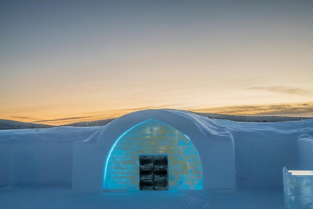 A vaulted corridor cut from snow and ice